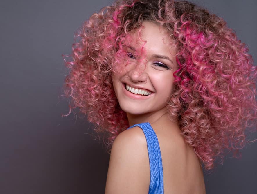 curly hair with pink highlights