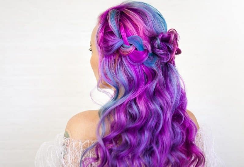 curly half up half down braided hairstyle with galaxy hair