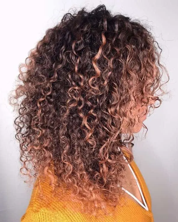 curly lob with rose gold highlights