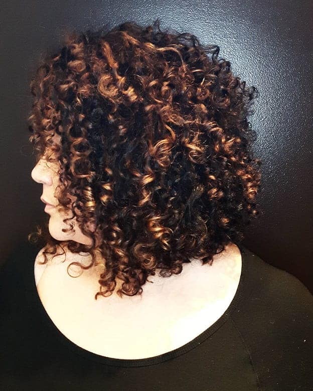 inverted curly bob with copper highlights