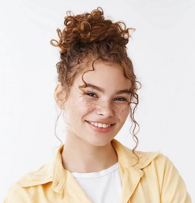 messy bun with ginger curly hair