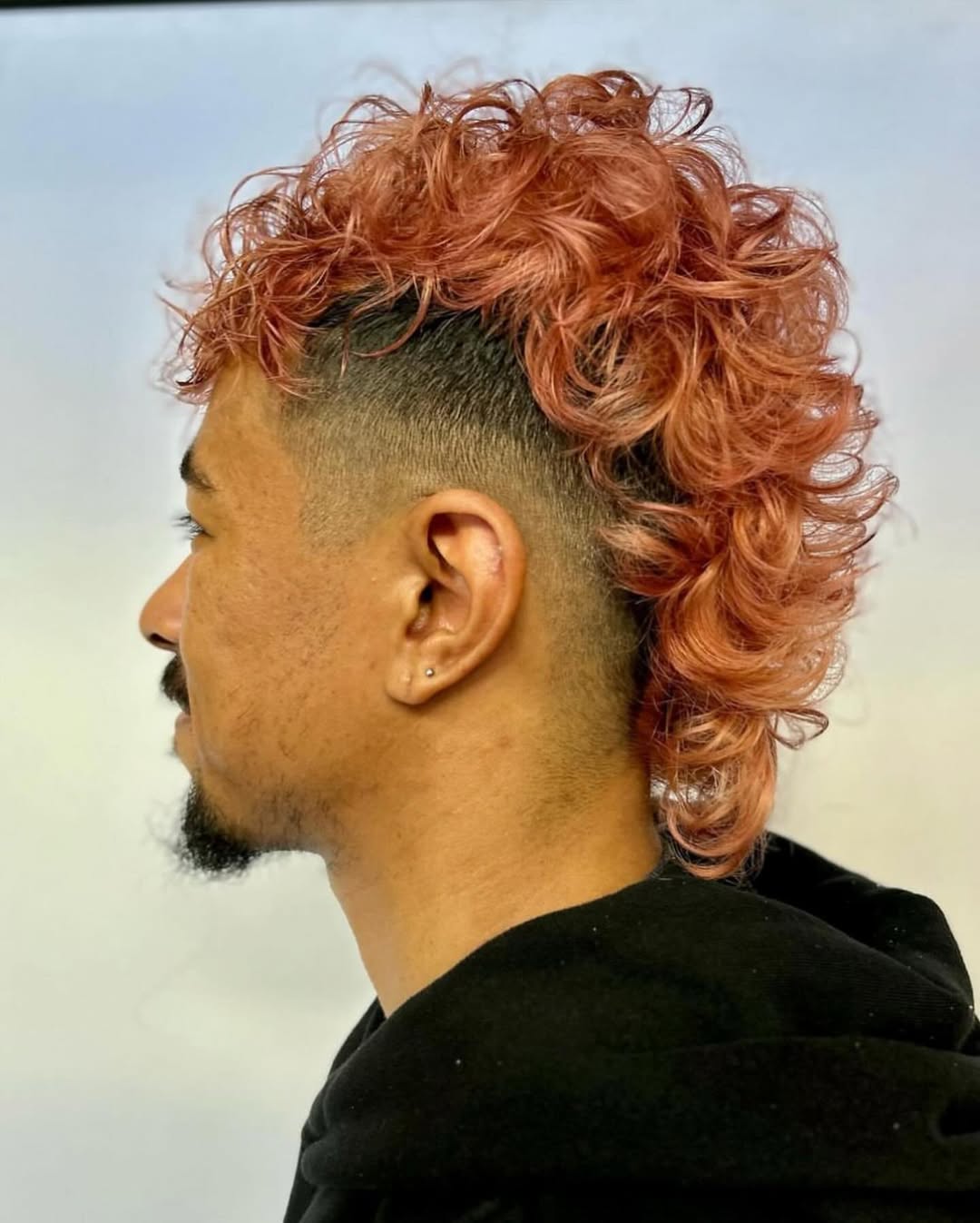 Dyed curly mohawk taper fade hairstyle