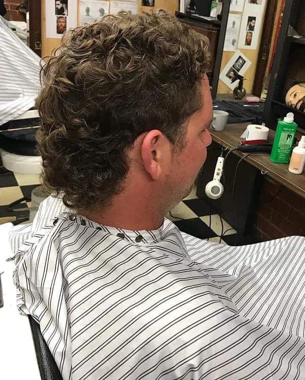 guy with curly mullet hair