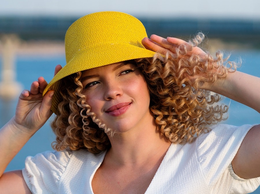 curly perm hairstyle with sun hat