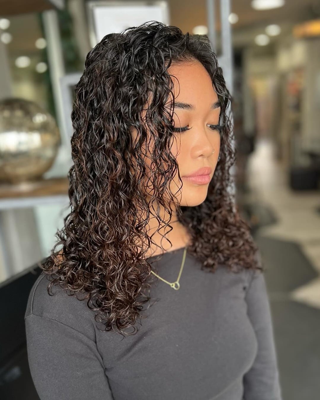 dark wet-look curly perm on thin hair