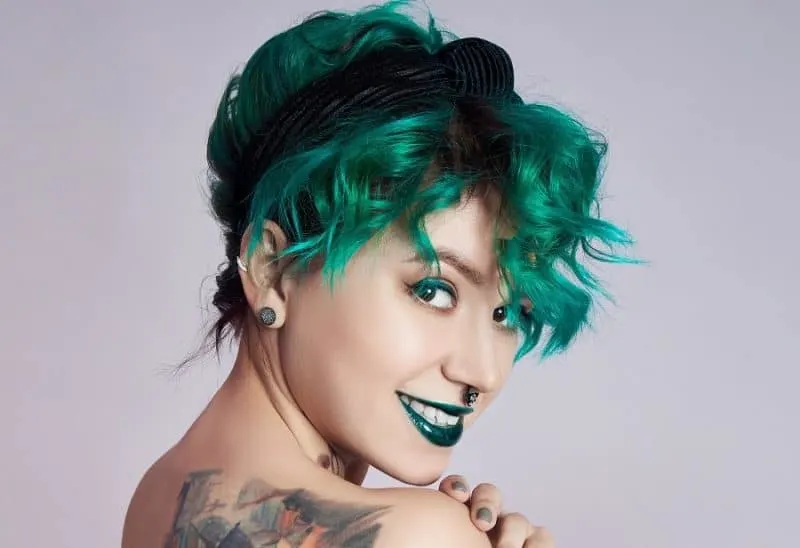 curly pixie cut with green hair color