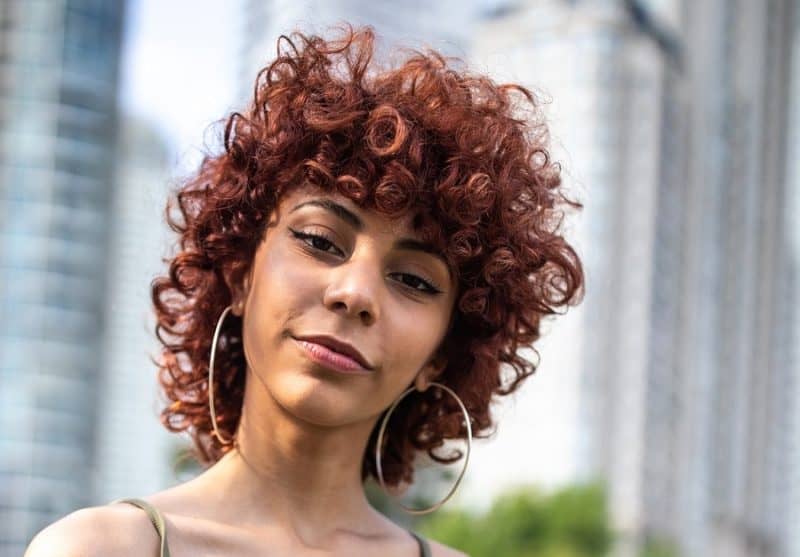 curly shag haircut with copper red hair
