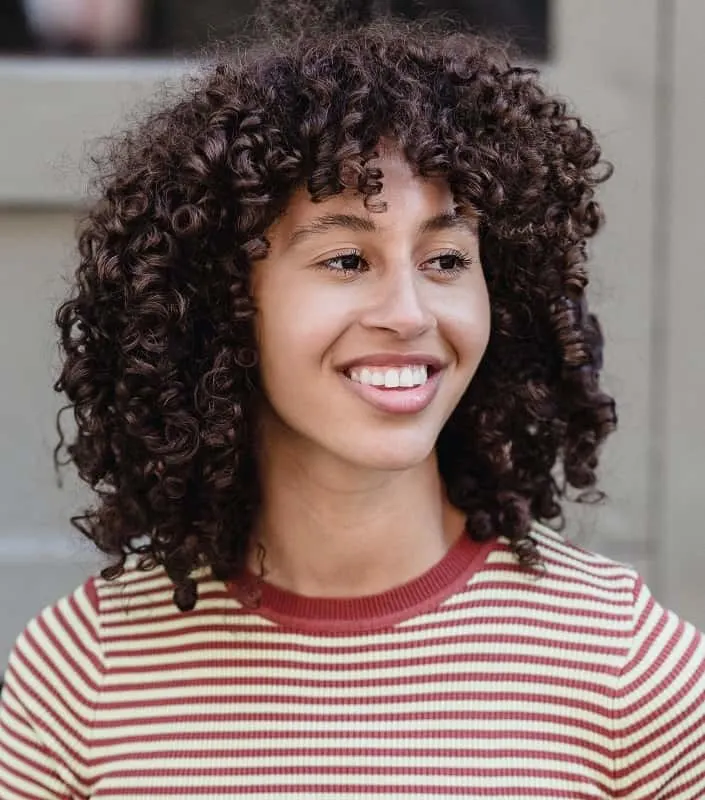 curly short in front long in back hairstyle