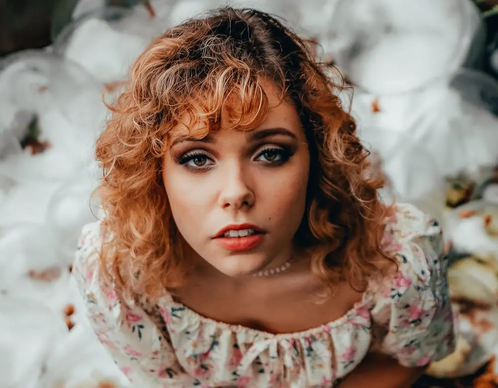 curly side parted hair with bangs