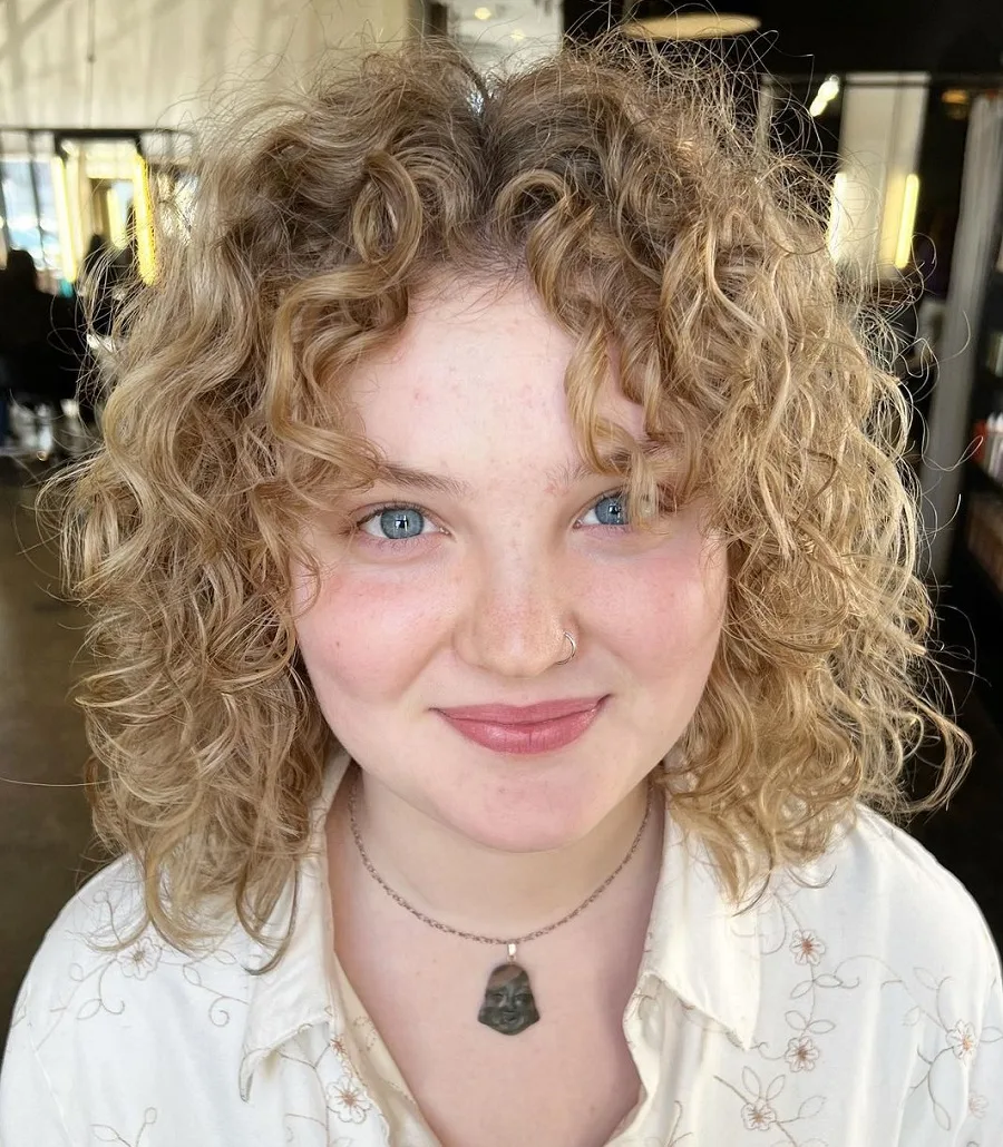 curly wolf cut on blonde hair