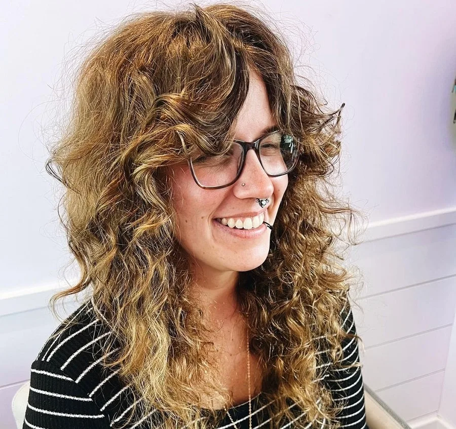 thick curly hair with curtain bangs