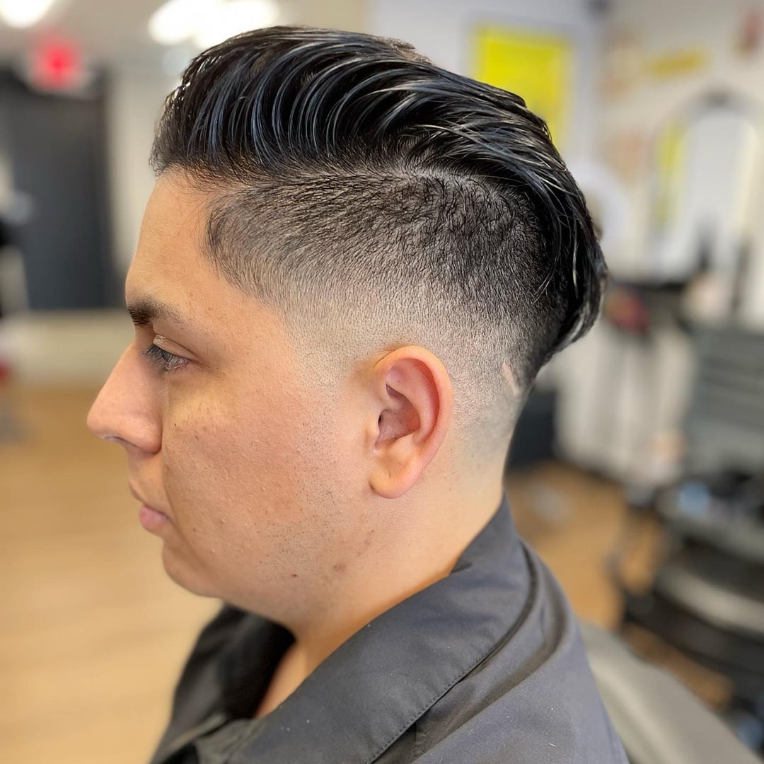 slicked-back mohawk style with disconnected fade
