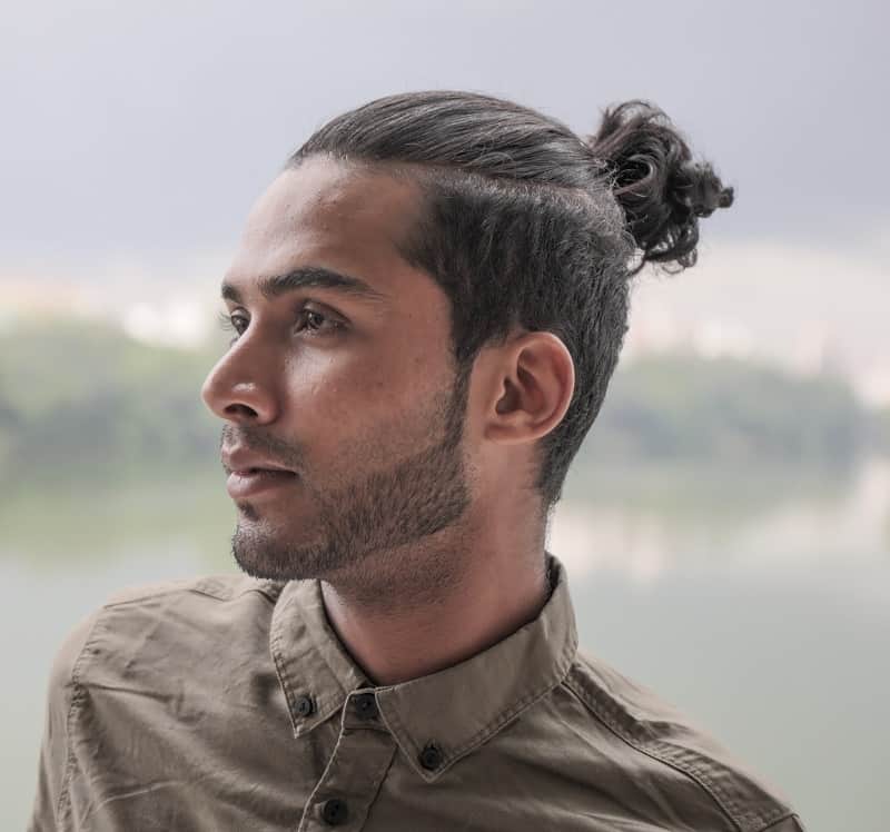 A picture of a guy with a long hair undercut hairstyle and a manbun - Man  Bun Hairstyle