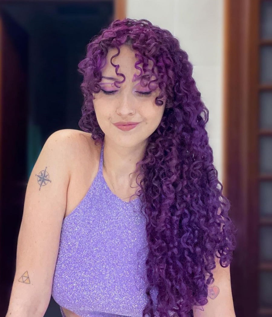 dyed curly hair with curtain bangs