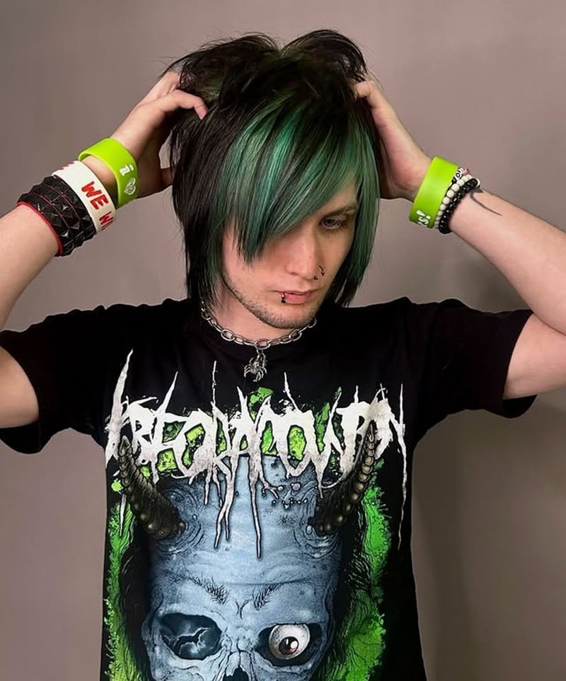 Emo boy with straight long black hair and dyed green side-swept bangs