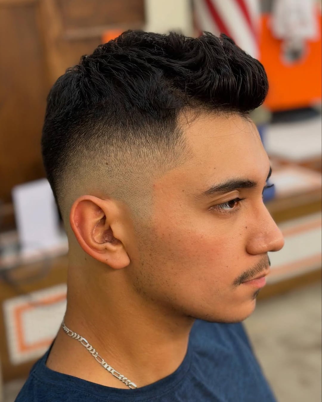 textured faded faux hawk haircut with mid skin fade