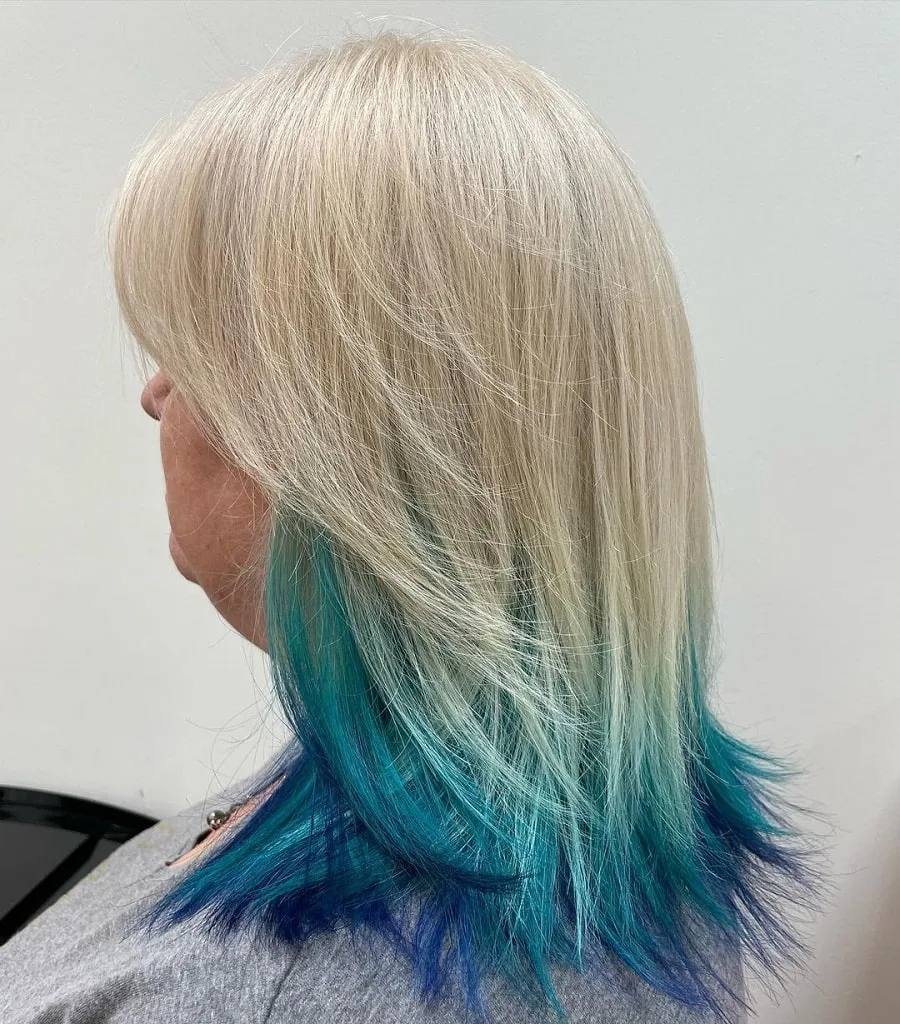 Feathered blonde hair with blue underneath