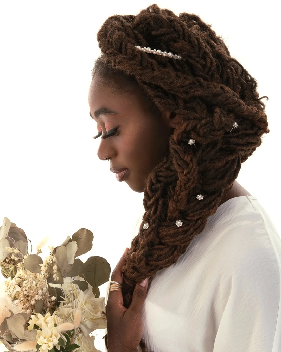 bridal side fishtail braid made with thick brown dreadlocks