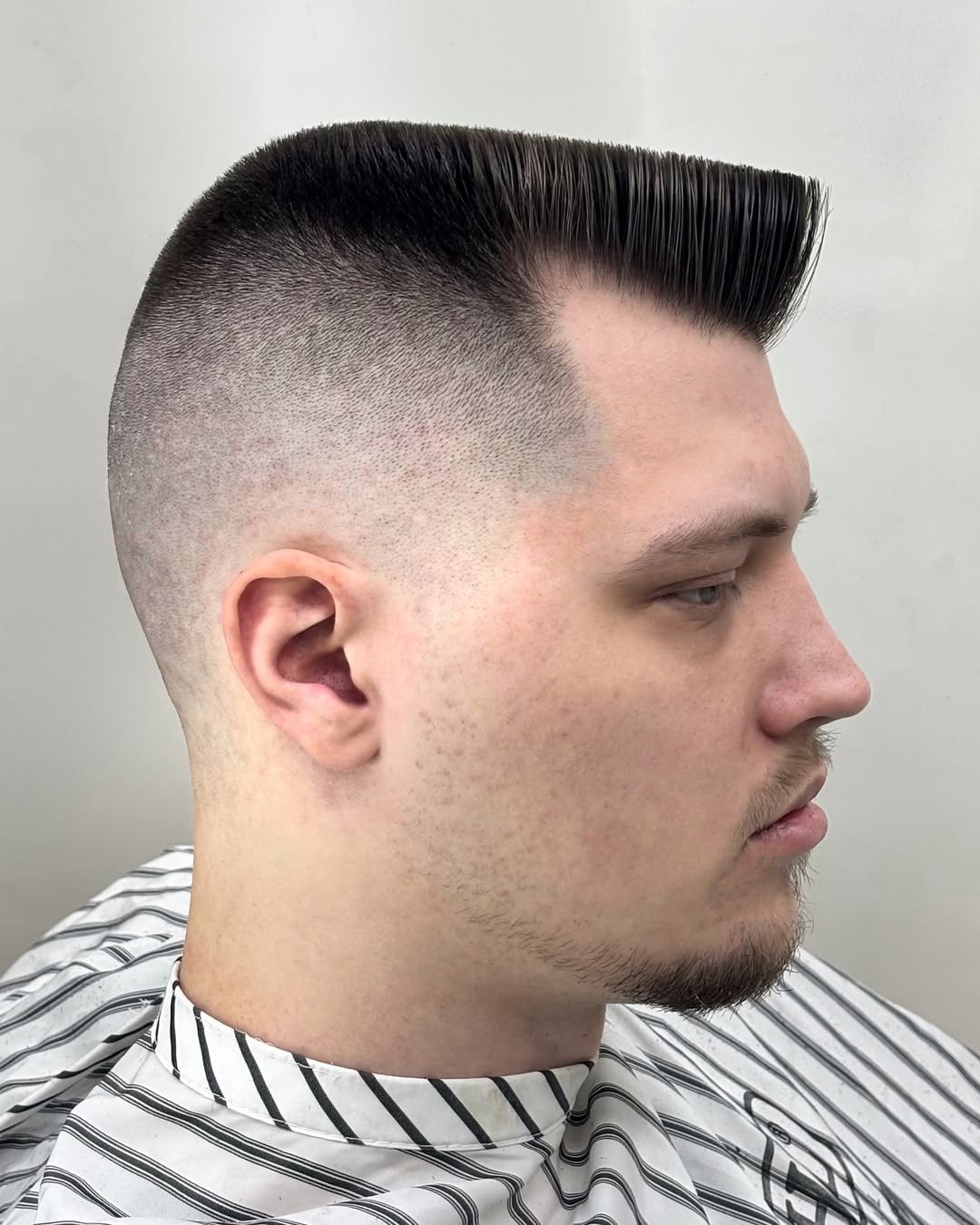 Sleek flat top haircut with a smooth skin fade