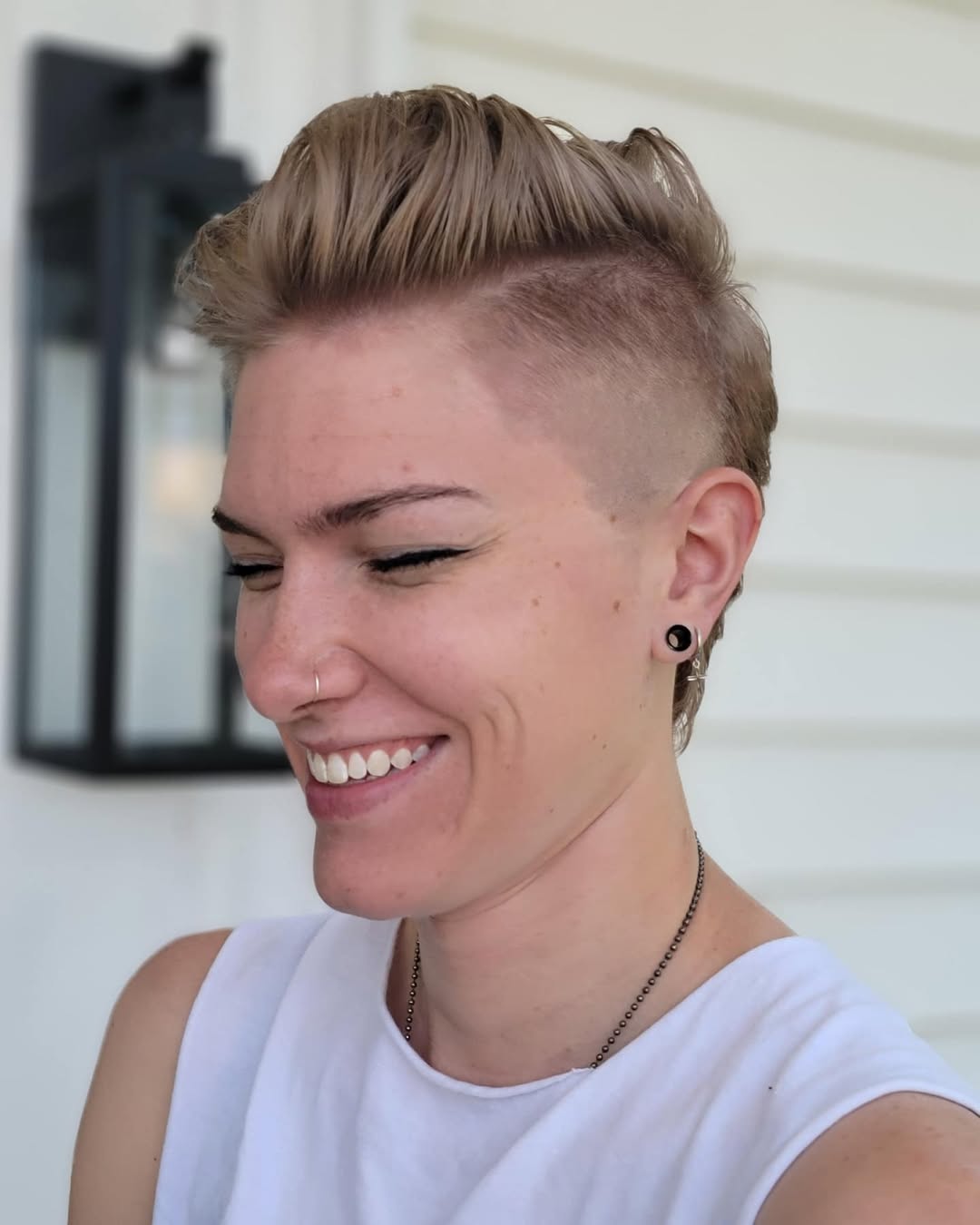 blonde fohawk undercut hairstyle for women with shaved sides
