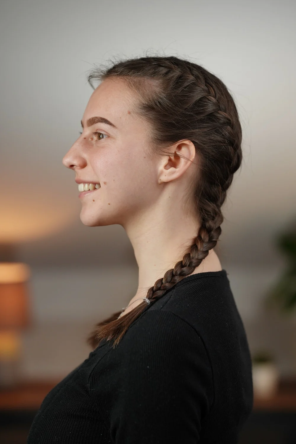 Side view of a French braid: the plait lies flat against the head because the strands are crossed over