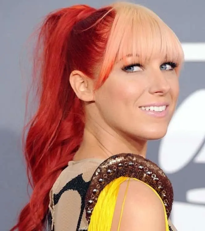 red ponytail with blonde bangs and blue eyes