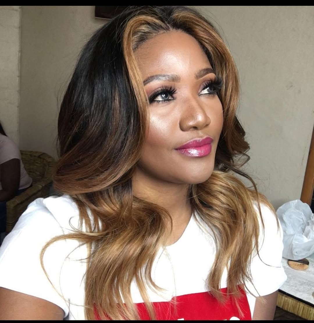 Golden caramel balayage hair color with face-framing highlights and soft waves for dark skin