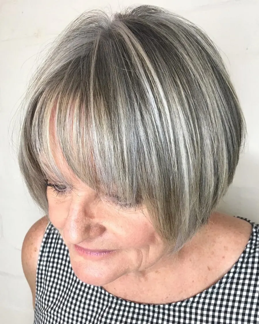 gray bob with bangs and blonde highlights