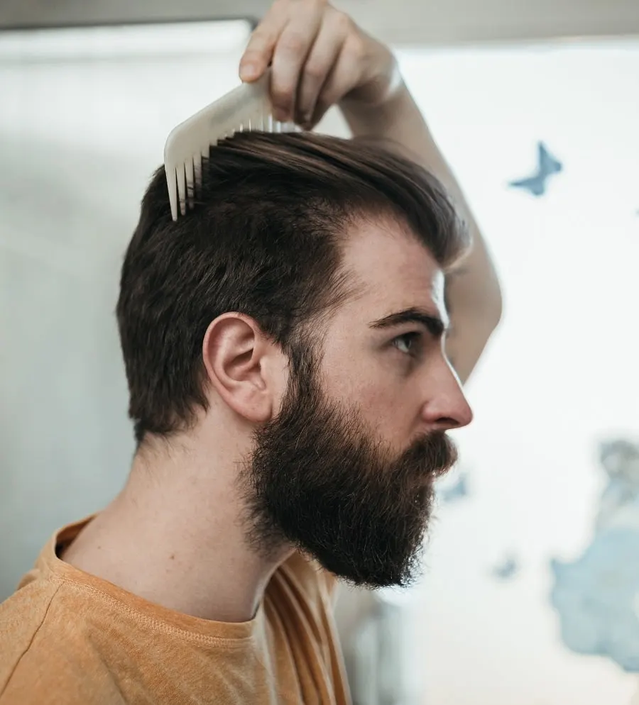 guy combing hair to sweep back