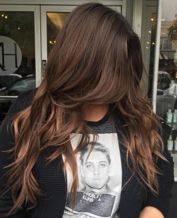 long layered wavy hairstyle with side part