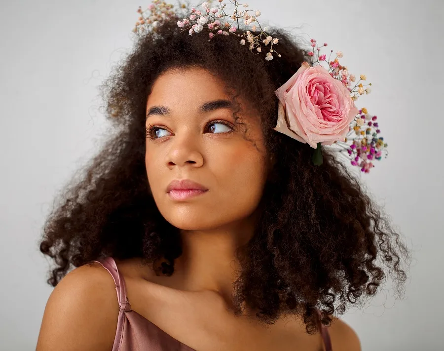 half up curly hair with flower