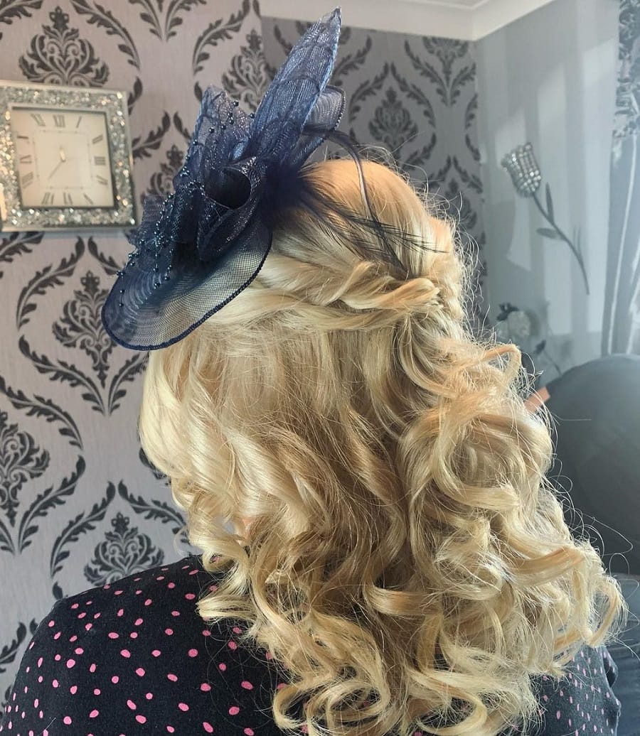 half up hairstyle with a hat for mother of the brides