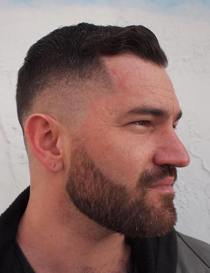 High and tight haircut with clean faded sides framing receding temples