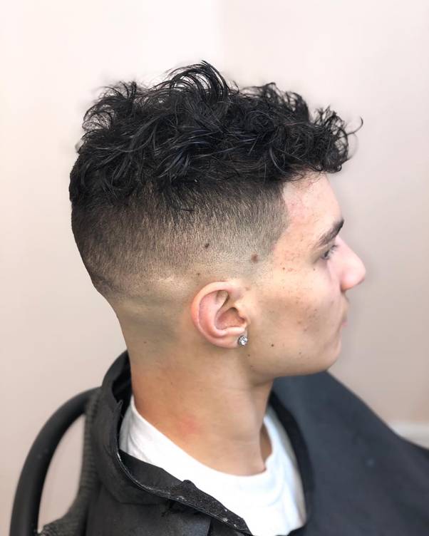 high bald fade with messy top