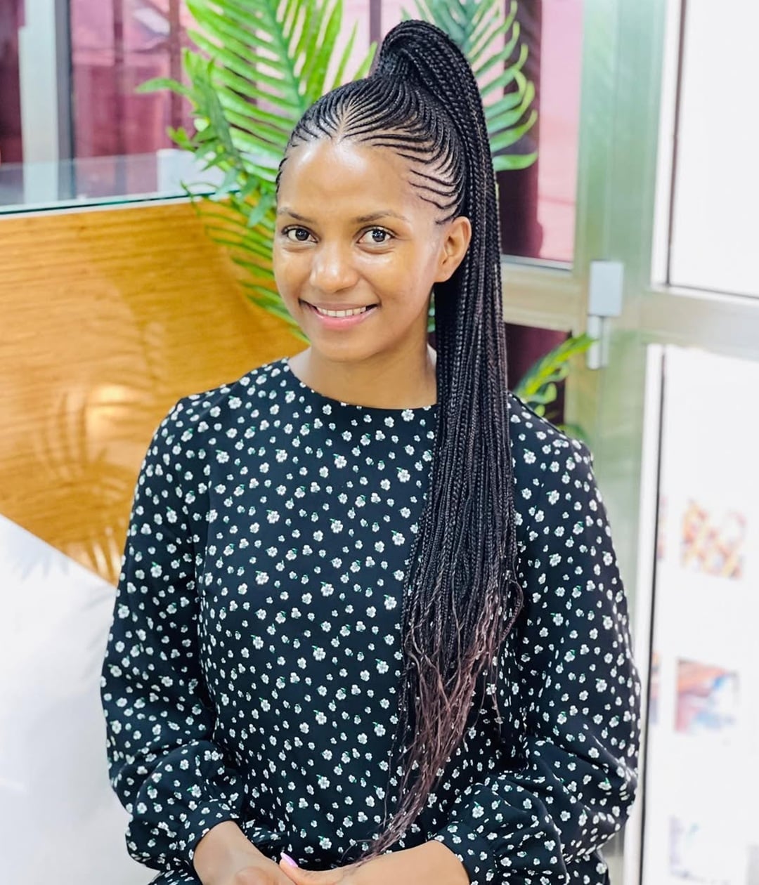 sleek feed-in cornrows gathered into a long high ponytail with marley braids