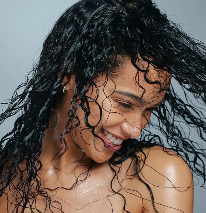 Woman with wet curly hair illustrating how often should you co-wash