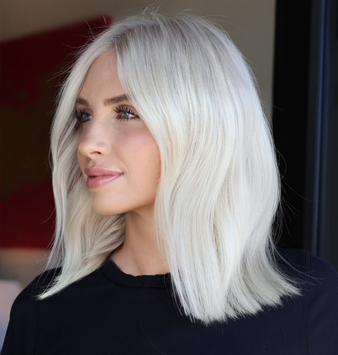 Shoulder length wavy lob haircut in bright icy platinum blonde hair color