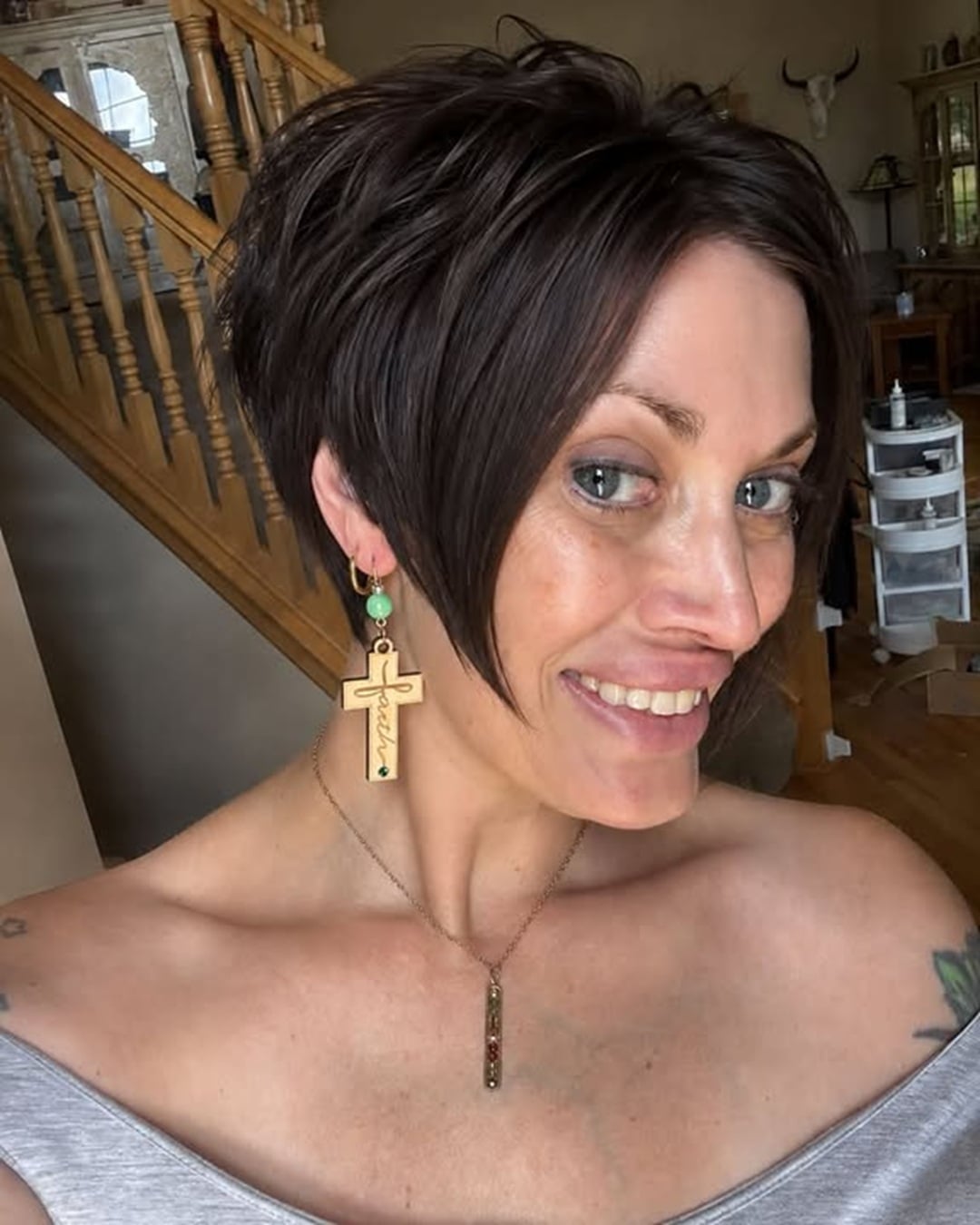Woman with a dark brown angled pixie bob styled as a softer take on classic Karen haircut