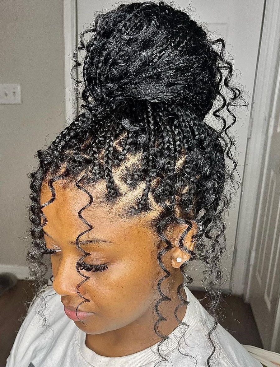 A loose braided bun with curly ends