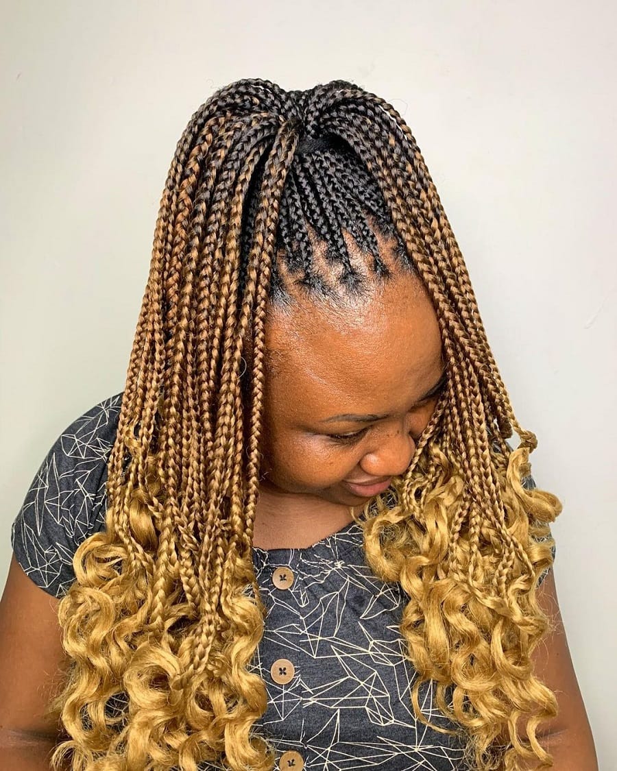 A knotless braided ponytail with curly ends