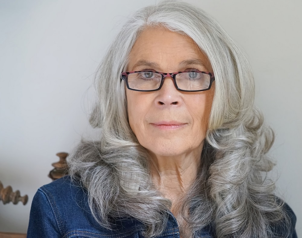 layered gray hairstyle for over 50 with glasses