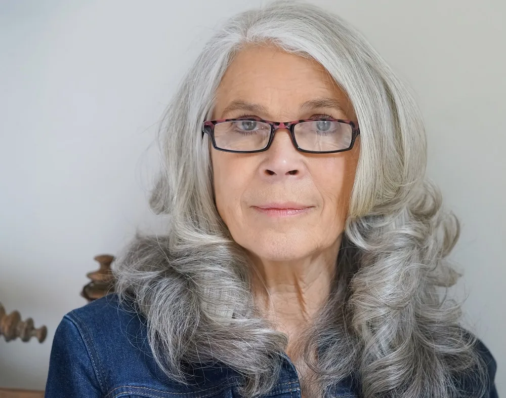 layered gray hairstyle for over 50 with glasses