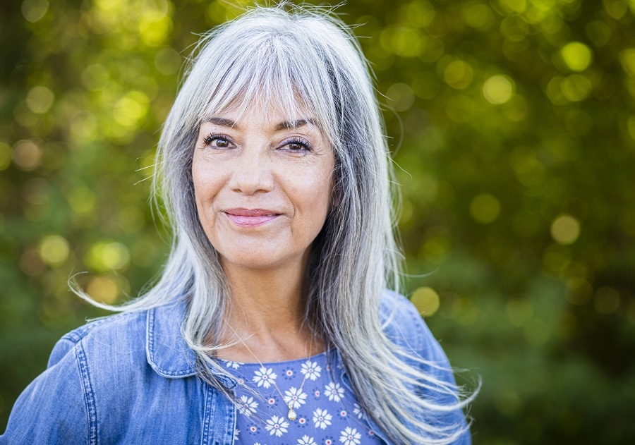 Layered hairstyle with bangs for women over 60