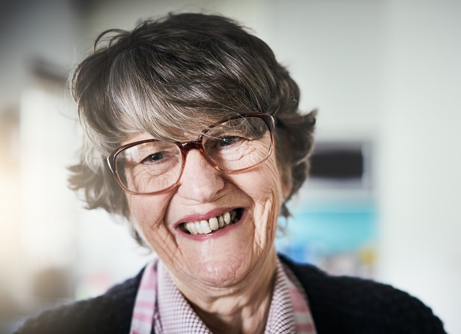 layered pixie cut for 80 year old woman with glasses