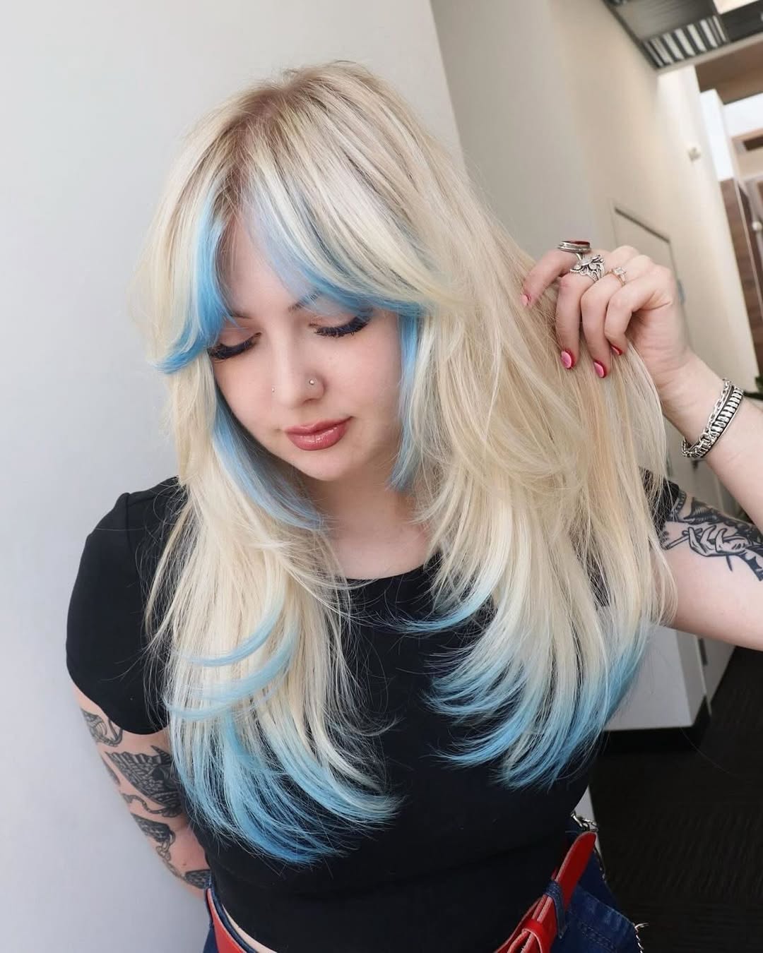 Long layered platinum blonde hair with pastel blue money piece curtain bangs and dip-dyed tips