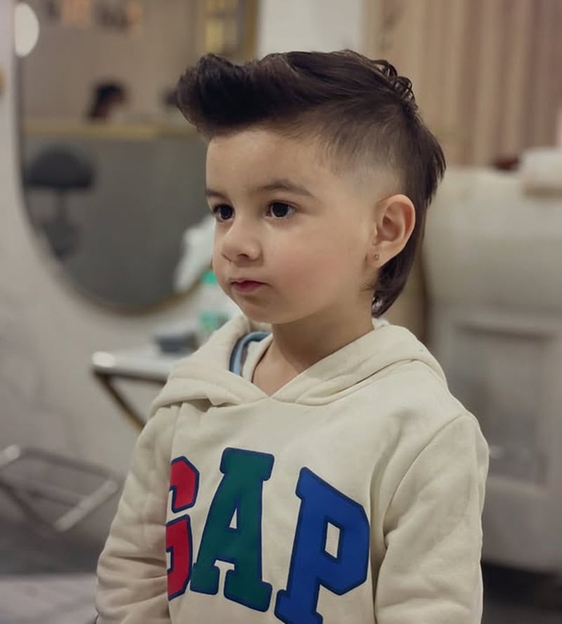 little boy with modern mullet fade haircut, styled for straight hair