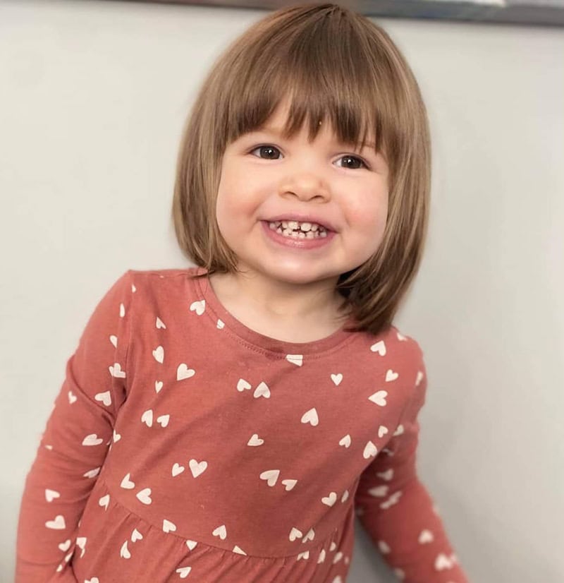 girl with a classic blunt bob haircut and straight bangs.