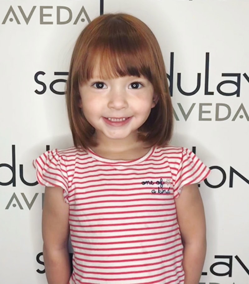 little girl shoulder-length bob hairstyle with wispy fringe bangs