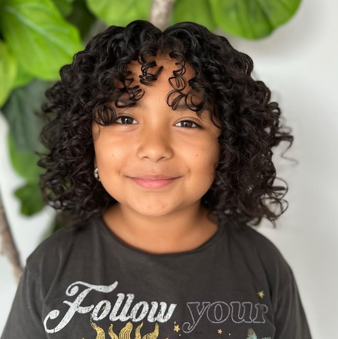 little girl with curly bob and curly bangs