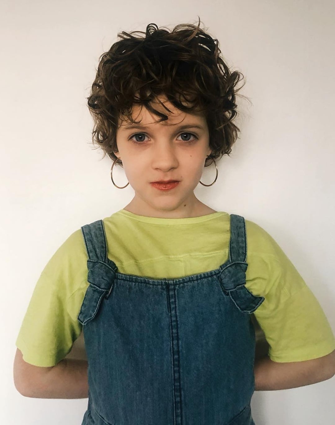 little girl with short, messy curly pixie bob and soft curly fringe